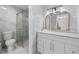 Bathroom featuring modern vanity, tiled walls, a glass-enclosed shower, and gold fixtures at 89 De Arc Nw Pl, Atlanta, GA 30327