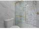 Close-up of the shower featuring gold hardware and grey and white tile at 89 De Arc Nw Pl, Atlanta, GA 30327