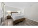 Bedroom with a wooden bed frame, neutral decor, wood-look flooring, and bedside lamps at 89 De Arc Nw Pl, Atlanta, GA 30327