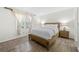 Bedroom featuring a wooden bed frame, neutral decor, wood-look flooring, and natural light from the window at 89 De Arc Nw Pl, Atlanta, GA 30327