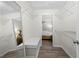 Walk-in closet with wire shelving, mirror, bench, and view into the bedroom at 89 De Arc Nw Pl, Atlanta, GA 30327