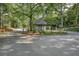 A picturesque entrance with lush trees and well-manicured landscaping for a tranquil community at 89 De Arc Nw Pl, Atlanta, GA 30327