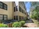 Exterior view of a two-story building featuring multiple windows, balconies, green landscape and parking at 89 De Arc Nw Pl, Atlanta, GA 30327