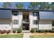 Traditional-style condo with neutral paint, black shutters, and mature landscaping at 89 De Arc Nw Pl, Atlanta, GA 30327