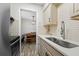 Kitchen showcasing stainless steel appliances, tile backsplash, and a view into the dining area at 89 De Arc Nw Pl, Atlanta, GA 30327