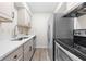 This is a kitchen with stainless steel appliances, subway tile backsplash, and light wood-look flooring at 89 De Arc Nw Pl, Atlanta, GA 30327