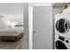 Washer and dryer in a small room that also has a door leading into a bedroom at 89 De Arc Nw Pl, Atlanta, GA 30327