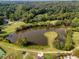 Aerial view of a scenic pond surrounded by greenery, offering a peaceful natural amenity within the community at 89 De Arc Nw Pl, Atlanta, GA 30327
