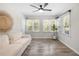 Bright sun room with white walls, wood-look flooring, and large windows at 89 De Arc Nw Pl, Atlanta, GA 30327