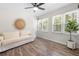 Inviting sun room with a comfortable sofa and beautiful green plants at 89 De Arc Nw Pl, Atlanta, GA 30327