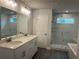 Luxury bathroom with a walk-in shower, double vanity, and modern fixtures at 138 Briargate Dr, Johns Creek, GA 30097