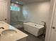 Luxury bathroom with a freestanding tub, walk-in shower, and double vanity at 138 Briargate Dr, Johns Creek, GA 30097