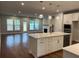 Bright living room with hardwood floors, fireplace, and kitchen island at 138 Briargate Dr, Johns Creek, GA 30097