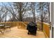 An outdoor back deck with wooden railings and planks, a grill, and outdoor seating at 1814 Dupont Nw Ave, Atlanta, GA 30318