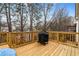 An outdoor back deck with wooden railings and planks and a grill at 1814 Dupont Nw Ave, Atlanta, GA 30318