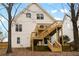 A back exterior view of a two-story home with a wooden back deck and stairs at 1814 Dupont Nw Ave, Atlanta, GA 30318