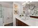 Stylish bathroom features glass shower, double vanity with ample counter space, framed prints, and modern fixtures at 1814 Dupont Nw Ave, Atlanta, GA 30318