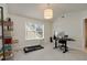 Inviting bedroom/office with neutral walls, carpet, a treadmill and natural light, providing a serene and functional space at 1814 Dupont Nw Ave, Atlanta, GA 30318