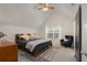 Bright bedroom featuring a ceiling fan, vaulted ceilings, window, and cozy decor for a relaxing ambiance at 1814 Dupont Nw Ave, Atlanta, GA 30318