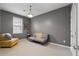 This bedroom has gray walls, carpet floors, a sofa, and a light fixture at 1814 Dupont Nw Ave, Atlanta, GA 30318