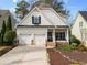 Charming two-story home with a two-car garage, stone accents, and a cozy front porch at 1814 Dupont Nw Ave, Atlanta, GA 30318