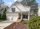 Inviting two-story home showcasing a two-car garage, stone accents, and a charming front porch area at 1814 Dupont Nw Ave, Atlanta, GA 30318