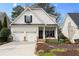 Charming two-story home featuring a well-maintained front yard and a two-car garage at 1814 Dupont Nw Ave, Atlanta, GA 30318