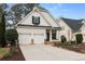 Charming two-story home featuring a well-maintained front yard and a two-car garage at 1814 Dupont Nw Ave, Atlanta, GA 30318