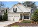 Charming two-story home featuring a well-maintained front yard and a two-car garage at 1814 Dupont Nw Ave, Atlanta, GA 30318