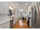 Bright, open kitchen with white cabinets, modern appliances, and wood floors, perfect for cooking at 1814 Dupont Nw Ave, Atlanta, GA 30318
