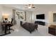 Bright living room with a leather couch, desk with computers, mounted TV, and large windows letting in ample natural light at 1814 Dupont Nw Ave, Atlanta, GA 30318