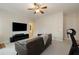 Bright living room with a ceiling fan, carpeted floors, a brown couch, and a mounted TV at 1814 Dupont Nw Ave, Atlanta, GA 30318