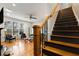 View of the stairway featuring hardwood floors, black risers, and a stained handrail at 1814 Dupont Nw Ave, Atlanta, GA 30318