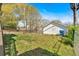 View of the backyard with a detached white garage and mature trees at 638 Bryan Se St, Atlanta, GA 30312