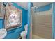A compact bathroom features a shower with glass doors and floral curtains at 638 Bryan Se St, Atlanta, GA 30312
