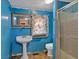 A compact bathroom features a stand alone sink and a shower with glass doors at 638 Bryan Se St, Atlanta, GA 30312