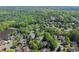 An aerial view displays a leafy neighborhood adjacent to a pond, emphasizing community and outdoor appeal at 2314 Edgemere Lake Cir, Marietta, GA 30062
