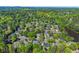 An aerial view highlights a neighborhood surrounded by mature trees with lake views, providing a tranquil and picturesque setting at 2314 Edgemere Lake Cir, Marietta, GA 30062