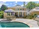 Inviting backyard with pool, patio area, outdoor kitchen, lush greenery, perfect for entertaining and relaxation at 2314 Edgemere Lake Cir, Marietta, GA 30062