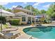 Stunning backyard with pool, lounge chairs, patio seating and lush landscaping creating a serene outdoor oasis at 2314 Edgemere Lake Cir, Marietta, GA 30062