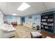 Finished basement with blue walls, white furniture, a patterned rug, and a large bookshelf with books at 2314 Edgemere Lake Cir, Marietta, GA 30062