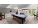 Spacious finished basement with a pool table, foosball table, and walkout to patio at 2314 Edgemere Lake Cir, Marietta, GA 30062