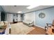 Finished basement with laminated wood flooring, blue walls, comfortable seating, and white closet doors at 2314 Edgemere Lake Cir, Marietta, GA 30062