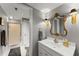 Bright bathroom featuring a gold mirror and sconces, a shower with a glass door, and a white vanity at 2314 Edgemere Lake Cir, Marietta, GA 30062