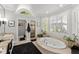 Bright bathroom with a large soaking tub, walk-in shower, and double vanity offering a spa-like experience at 2314 Edgemere Lake Cir, Marietta, GA 30062