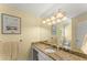 Bathroom featuring granite countertops, a sink, and a large framed mirror at 2314 Edgemere Lake Cir, Marietta, GA 30062