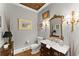 Chic powder room featuring a decorative mirror, elegant vanity, and stylish lighting fixtures at 2314 Edgemere Lake Cir, Marietta, GA 30062