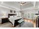 Bright bedroom featuring hardwood floors, tray ceilings and french doors that lead to a private balcony at 2314 Edgemere Lake Cir, Marietta, GA 30062