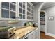 Butler's pantry with granite countertops, custom cabinets, and a convenient beverage station at 2314 Edgemere Lake Cir, Marietta, GA 30062