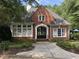 Charming brick home with arched entryway, manicured landscaping, and a welcoming front porch at 2314 Edgemere Lake Cir, Marietta, GA 30062